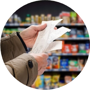 man holding shopping receipts in a grocery store
